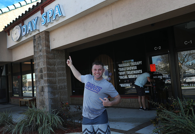 Mark McGuire, a N.Y. Giants football fan, stands near the front door of the Orchids of Asia Day Spa after New England Patriots owner Robert Kraft is charged with allegedly soliciting for sex.